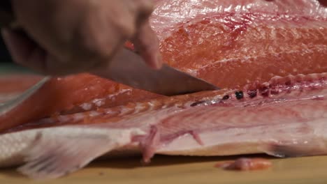 chef preparing fresh salmon in the kitchen