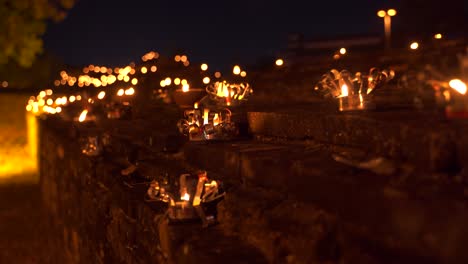 Close-up-of-candles-burning-on-stone-walls-of-Chiang-Mai,-Thailand