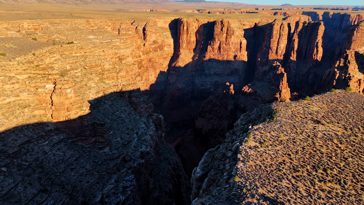 Footage over the edge of the canyon with steep cliffs. View on the river at the bottom of the dark canyon. Marble Canyon, Coconino County, Arizona, USA