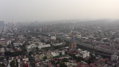 Aerial-jib-down-shot-of-a-very-polluted-Mexico-City