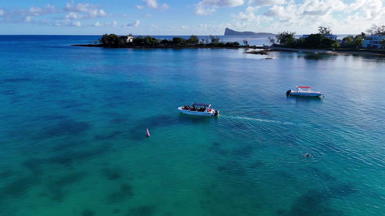 Mauritius boat trip with Gunners Island view. Turquoise waters, sunny day. Concept of tropical vacation, leisure, travel. Ideal for tourism, adventure, relaxation.