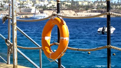 safety equipment, life buoy or rescue buoy on the wooden pier at the beach