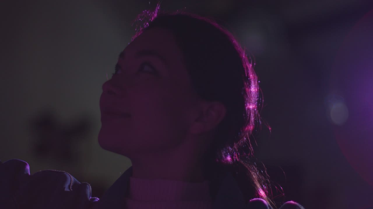 Woman Visiting And Interacting With Immersive Art Exhibition Backlit By Light From Projector 1