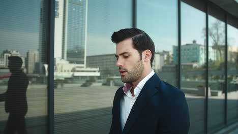 Portrait-man-walking-near-building.-Businessman-walking-up-stairs-outdoors