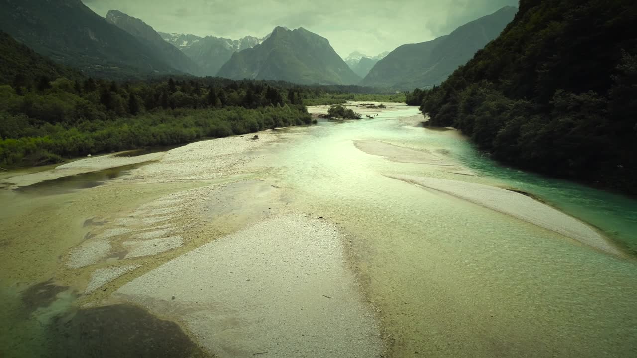 Aerial view of Soca river with clear water and rocks in Slovenia.