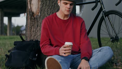 joven disfrutando de una pausa para el café en el parque