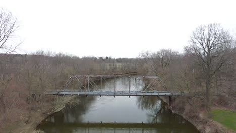 Abandoned-steel-truss-bridge-in-Burt,-Michigan-with-drone-video-moving-over