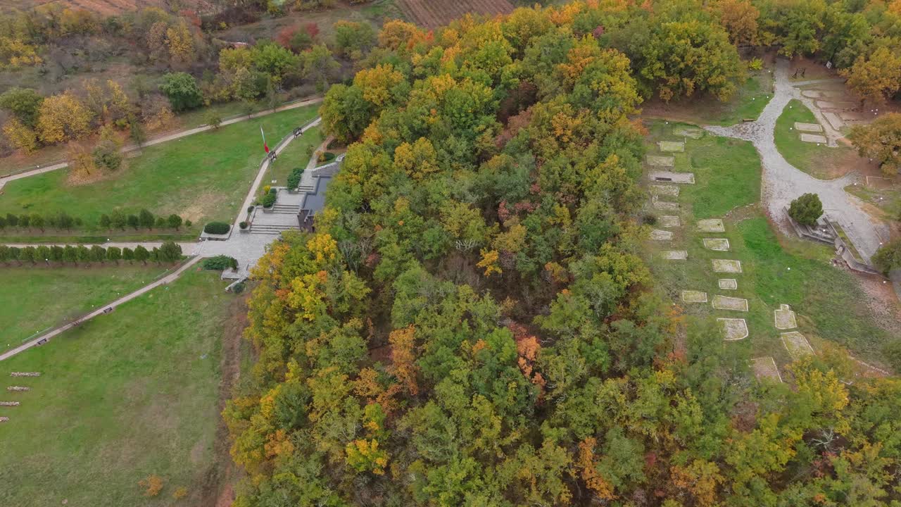Lateral drone shot reveals Samuil's Fortress perched on a hill in Bulgaria, showcasing the historic monument and surrounding scenic landscape from a dynamic perspective