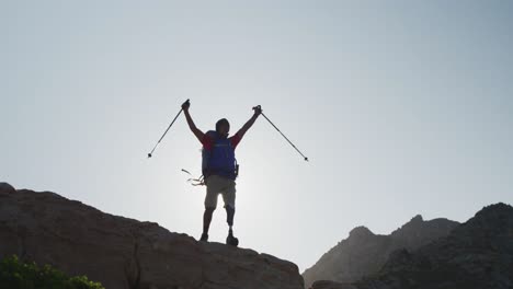 sporty mixed race man with prosthetic leg raising his arms