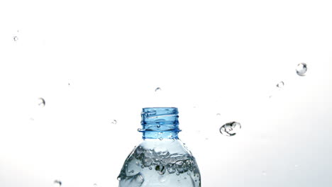 plastic bottle spilling out water on white background