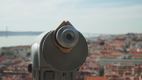 close up focus shot, telescope on the observation deck, blurred city of lisbon in the background