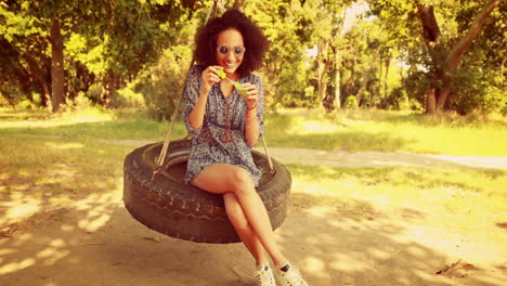 In-high-quality-4k-format-pretty-young-woman-in-tire-swing