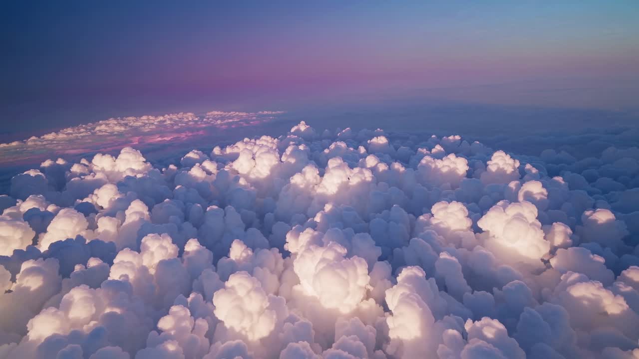 Aerial video captures fluffy clouds at sunset, angled diagonally, creating a serene and dreamy
