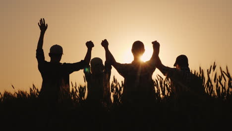 the team of farmers raise their hands up together in a sign of success and confidence in the team