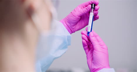 Working-In-Lab-Scientist-Holding-Test-Tubes-Positive-Test-Of-Covid-19-Coronavirus-At-Laboratory-5