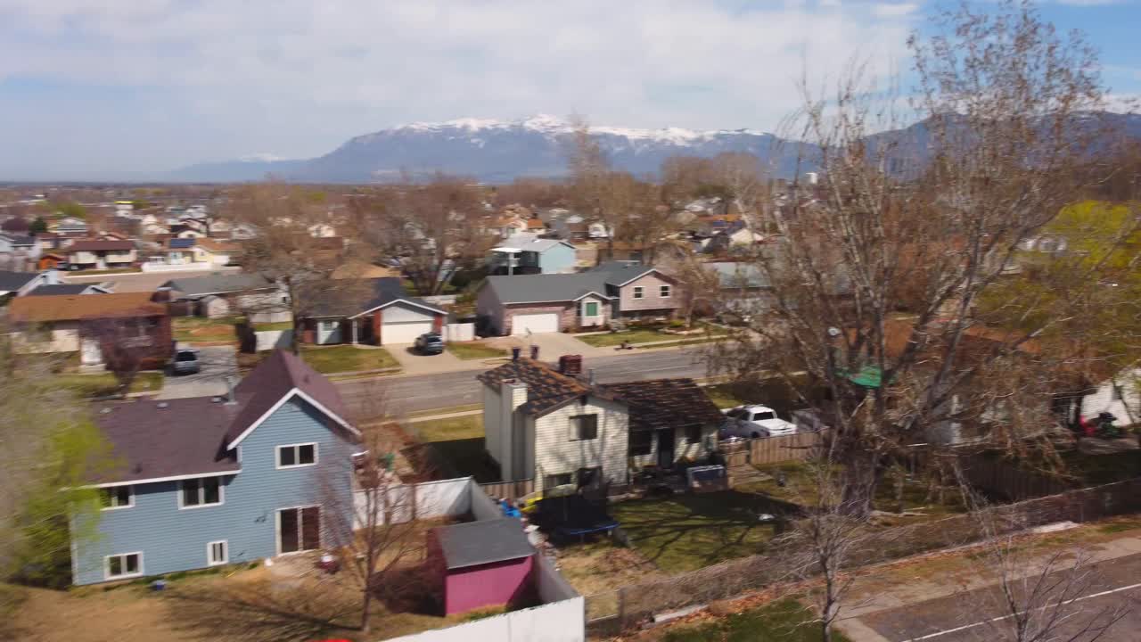 Drone flying fast through soccer (football) field goal post up to reveal construction area, and small park with baseball fiends in suburban rural neighborhood on a sunny spring summer day. In 4k.