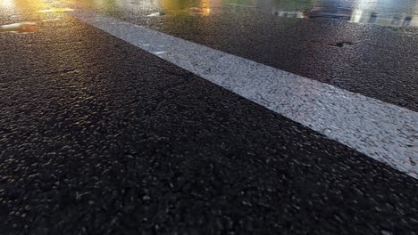 3d heavy rain hitting road at night - 4k realistic rain particle (loopable) - rainy day on a colorful street with traffic - wet road at night - low angle shot of in the rain - rainfall and reflection on road - loopable moving image - turkey - istanbul