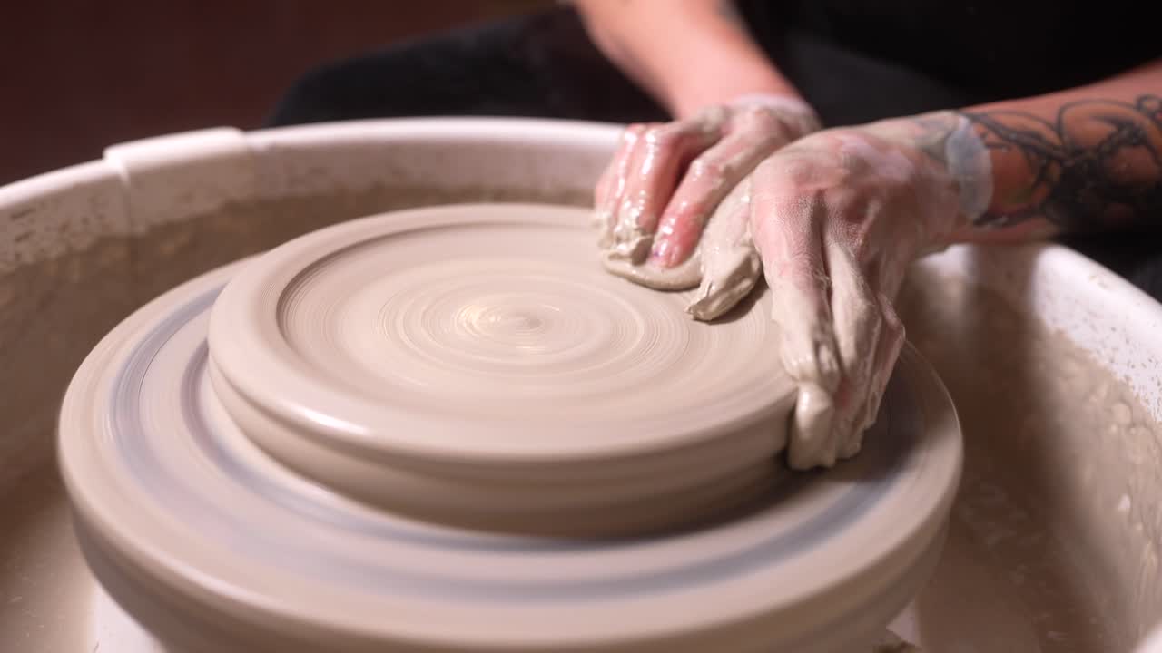 Close-up of a Potter's Hands Shaping Clay on a Spinning Wheel