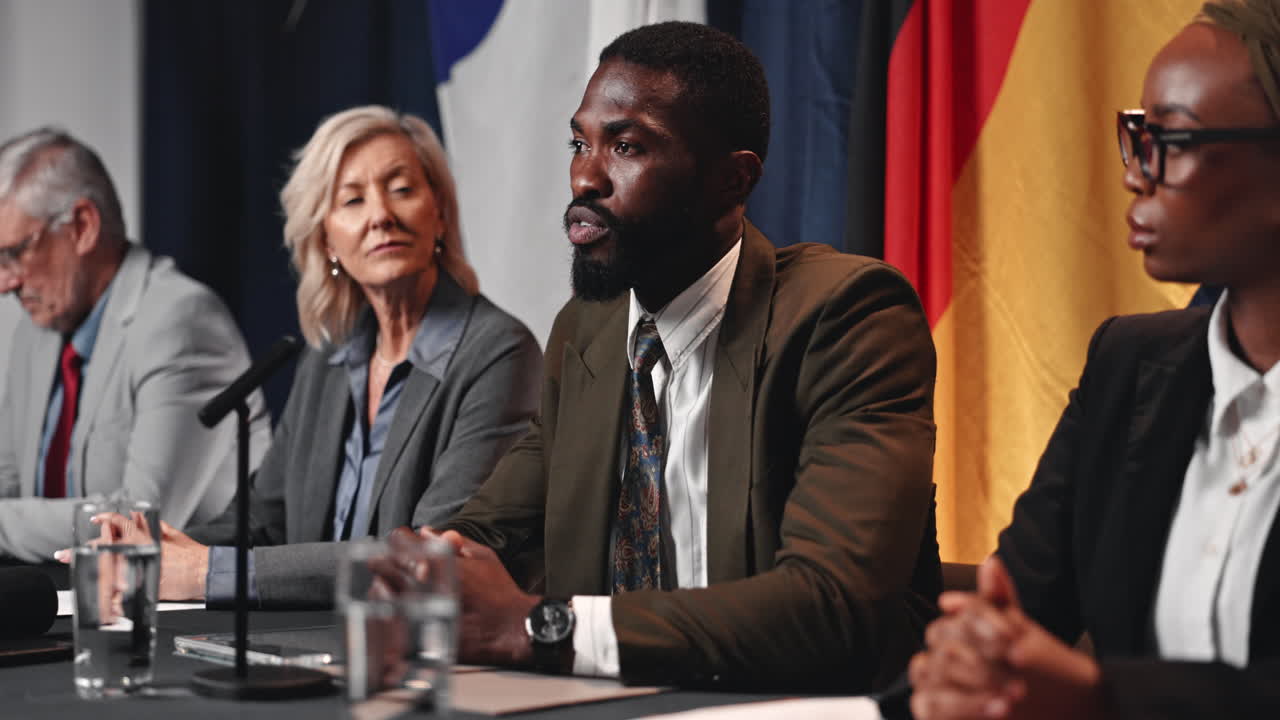 Press conference with speakers and flags