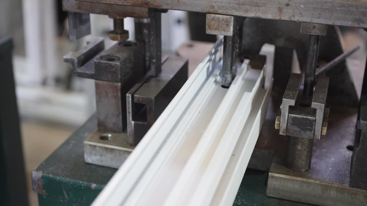 In a factory, a white pipe is being leaked by a machine