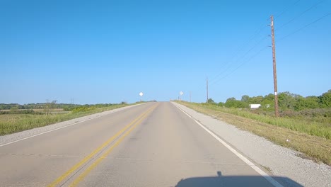 pov driving on a paved country road thru rural iowa