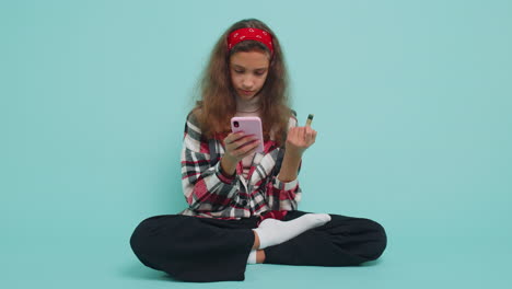 Child-girl-using-credit-bank-card-and-smartphone-while-transferring-money,-purchases-online-shopping