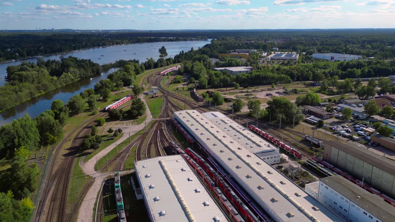 Hennigsdorf railway factory train depot overlooking the river in Brandenburg, Germany. Stunning aerial view flight fly reverse drone