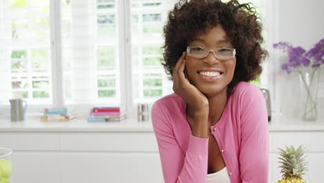 Smiling-woman-standing-in-kitchen