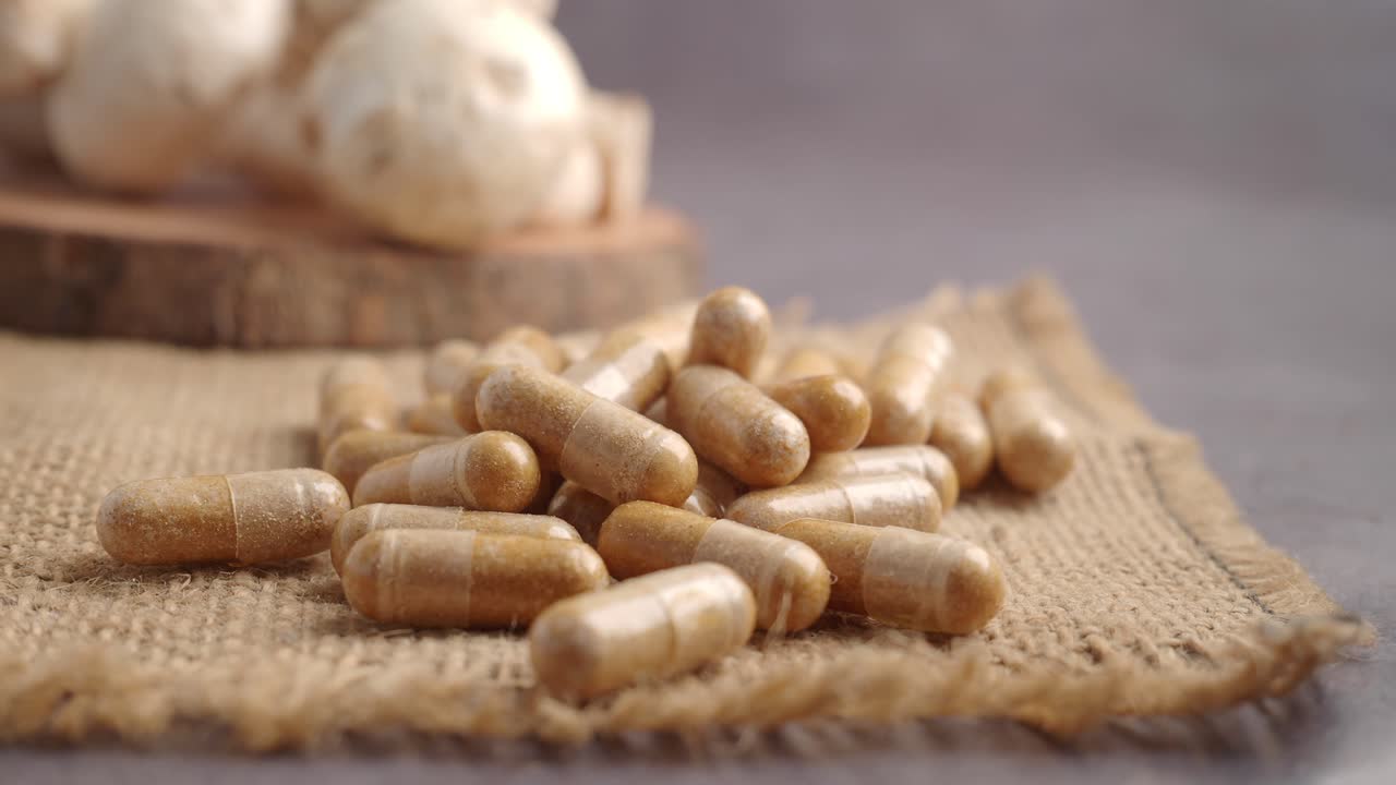 Natural Mushroom Supplement Capsules on Burlap Fabric