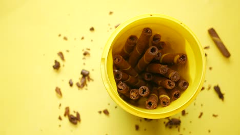 chocolate wafer rolls in a yellow container