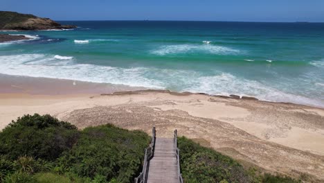 path to the frazer beach and deadmans beach with cottages in nsw, australia. - aerial shot