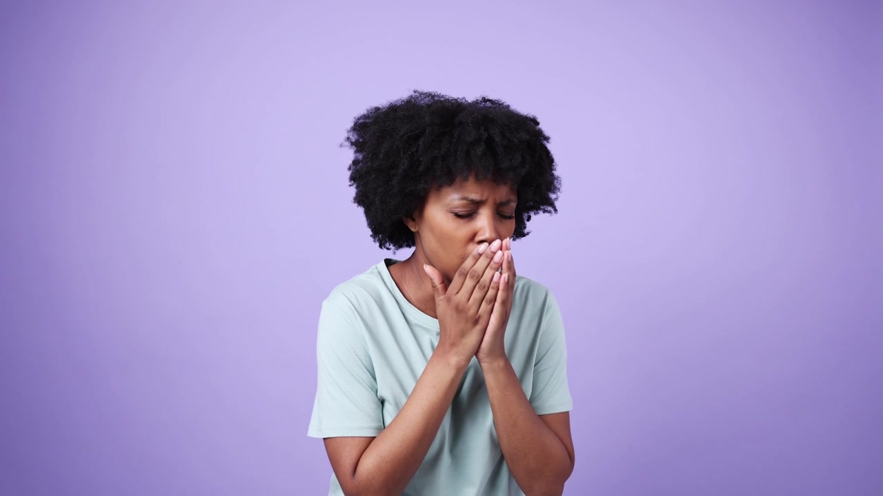 Young African American Woman Coughing and Holding Her Chest