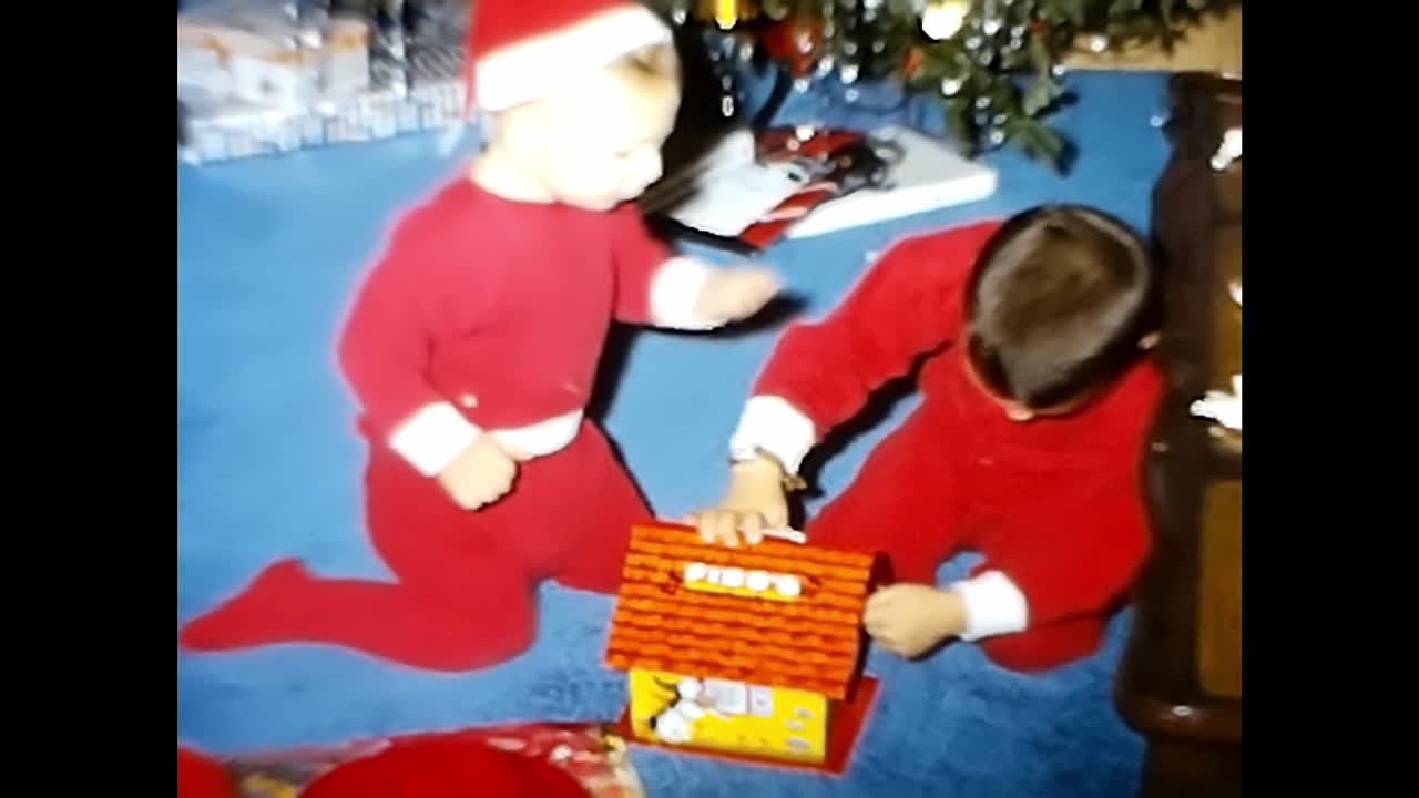Kids Sitting on the Floor. CIRCA USA - 1970s: Two children from a 1970s video archive in the USA are seated on the floor.