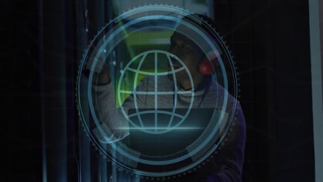 animation of web globe icon over african american male engineer using laptop at server room