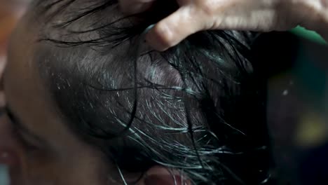 close-up of a person's wet hair being styled