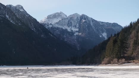 Lago-del-Predil,-Tarvisio---Italy-a-frozen-alpine-lake-in-a-snow-covered-winter-fairytale-mountain-landscape