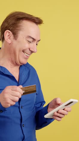 man making online payment with credit card and smartphone