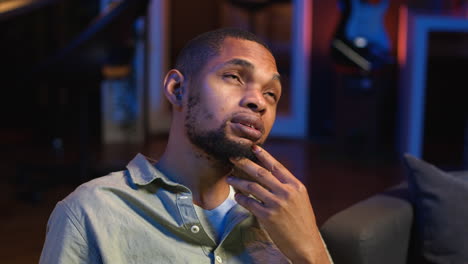 vertical video black teleworker thinking about ways to improve his productivity