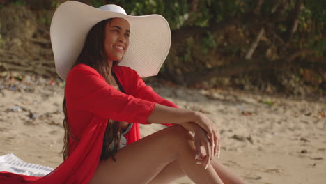 Young-Adult-Female-Latin-Model-Dressed-in-Style-on-Beach-Smiles-whilst-Poses-for-Camera