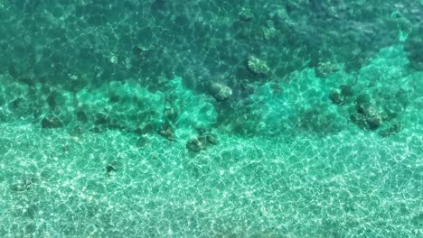 crystal clear turquoise waters gently lapping the shores of corfu island, sunlit, underwater view