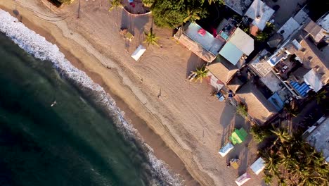 a top-down pedestal aerial shot of sayulita beach during sunset hours in mexico