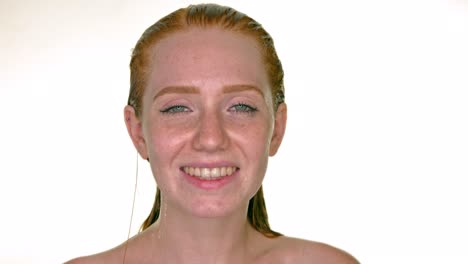 smiling redhead woman with wet hairs