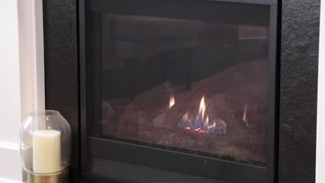 Glowing-fire-in-home-black-fireplace-with-wood