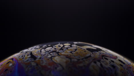 beautiful patterns of half a soap bubble on black background