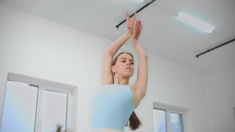 ballet dancer stretching in studio
