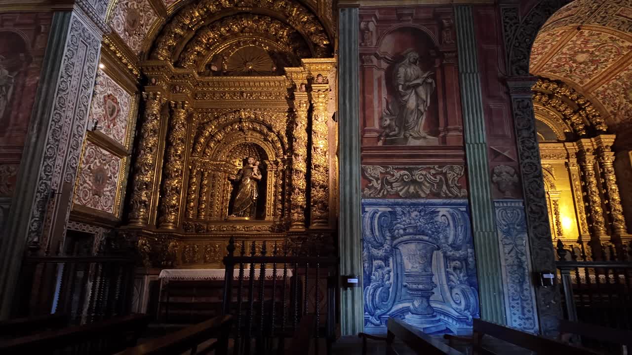 Interior view of a historic church in Funchal, Madeira, showcasing ornate golden altars, intricate religious artwork, and detailed architecture in cinematic video footage