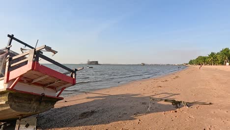 boat resting on sandy beach in pattaya