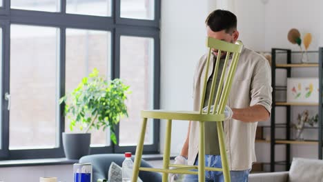 Man-Applying-Solvent-to-Rag-and-Cleaning-Old-Chair