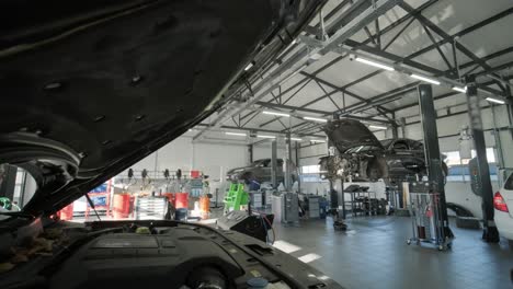 cars undergoing maintenance in auto repair shop