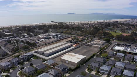 aerial wide reverse pullback shot of an industrial park in port hueneme with the channel islands visible in the distance